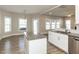 Spacious living room with hardwood floors, an island with granite countertops, and large windows at 43 Jonalker Ct, Clayton, NC 27520
