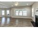 Spacious living room featuring a fireplace, large windows, and stylish wood-look flooring at 43 Jonalker Ct, Clayton, NC 27520