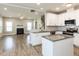 Open concept living room and kitchen with a fireplace, hardwood flooring, and white cabinets at 43 Jonalker Ct, Clayton, NC 27520