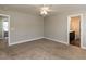 Spacious main bedroom with plush carpet, neutral walls, a ceiling fan, and ensuite bathroom at 43 Jonalker Ct, Clayton, NC 27520