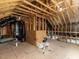 Unfinished attic with exposed beams, ductwork, and a small window at 43 Jonalker Ct, Clayton, NC 27520