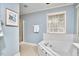 This bathroom has a soaking tub, tile flooring, and large window which provide lots of natural light at 4420 Dula St, Durham, NC 27705