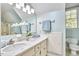 Bathroom features a double sink vanity with marble countertop and an oversized mirror at 4420 Dula St, Durham, NC 27705