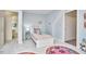 This bedroom is bright and cheery with colorful furniture and a plush flower rug at 4420 Dula St, Durham, NC 27705