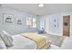 Inviting bedroom with light blue walls, neutral bed frame, and decorative art on the walls at 4420 Dula St, Durham, NC 27705
