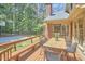 Spacious deck with dining furniture overlooks a backyard, with mature trees and basketball court at 4420 Dula St, Durham, NC 27705