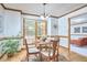 Cozy dining room features a round table, wood floors, natural light and neutral decor at 4420 Dula St, Durham, NC 27705