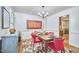 Dining room featuring a wooden table, pink chairs, two large windows, and modern art at 4420 Dula St, Durham, NC 27705