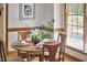 Charming dining area with wood floors, natural light, and table setting at 4420 Dula St, Durham, NC 27705