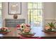 Close-up of a dining room table with a centerpiece, next to a window and dresser at 4420 Dula St, Durham, NC 27705