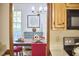 View from the kitchen of the adjacent dining room with blue dresser, table, and chandelier at 4420 Dula St, Durham, NC 27705