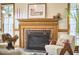 Elegant fireplace with a brick surround, mantel decor, and natural light at 4420 Dula St, Durham, NC 27705