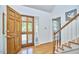 Welcoming foyer features hardwood floors, a wooden staircase, and natural light from the front door at 4420 Dula St, Durham, NC 27705