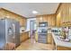 Spacious kitchen with wood cabinets, stainless steel appliances, and marble countertops at 4420 Dula St, Durham, NC 27705