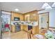 Kitchen with wooden cabinets, stainless steel appliances and view into the dining room at 4420 Dula St, Durham, NC 27705