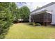 Spacious backyard featuring a screened-in porch, green lawn, and mature trees at 4913 Stockton Way, Durham, NC 27707