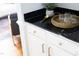 Stylish bar area with dark countertops, white cabinets, and decorative glassware at 4913 Stockton Way, Durham, NC 27707