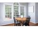Dining area featuring round wood table with black chairs and large window with blinds at 4913 Stockton Way, Durham, NC 27707