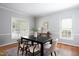 Cozy dining room featuring a modern table, hardwood floors, and natural light at 4913 Stockton Way, Durham, NC 27707