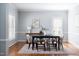 Elegant dining room with hardwood floors, wainscoting, and a modern black dining table at 4913 Stockton Way, Durham, NC 27707