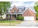 Charming two-story brick home with landscaped yard and attached two car garage at 4913 Stockton Way, Durham, NC 27707
