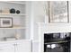 Close-up of a fireplace with black marble, white mantle, and surrounding built-in shelves at 4913 Stockton Way, Durham, NC 27707