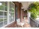 Relaxing front porch with chair, flowers and a view of the brick exterior at 4913 Stockton Way, Durham, NC 27707