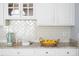 Close up of herringbone tile backsplash and granite countertops at 4913 Stockton Way, Durham, NC 27707