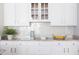 Kitchen countertop with white cabinets and herringbone tile backsplash at 4913 Stockton Way, Durham, NC 27707