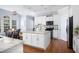 Bright kitchen featuring an island, white cabinets, and stainless steel appliances at 4913 Stockton Way, Durham, NC 27707