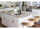 Kitchen island with granite countertop, cabinets, sink, and seating for two at 4913 Stockton Way, Durham, NC 27707
