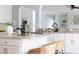 Bright kitchen features white cabinets, granite countertops, stainless steel appliances, and a kitchen island with chairs at 4913 Stockton Way, Durham, NC 27707
