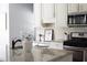 Kitchen featuring granite countertops, white cabinets, and stainless steel appliances at 4913 Stockton Way, Durham, NC 27707