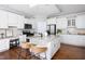 Bright kitchen with white cabinets, granite countertops, stainless steel appliances, and island with seating at 4913 Stockton Way, Durham, NC 27707