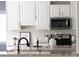 Elegant kitchen featuring white subway tile backsplash and stainless steel appliances at 4913 Stockton Way, Durham, NC 27707