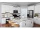 Bright kitchen with white cabinets, granite countertops, stainless steel appliances, and island with seating at 4913 Stockton Way, Durham, NC 27707