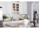 Updated kitchen with white cabinets, granite countertops, and a herringbone backsplash at 4913 Stockton Way, Durham, NC 27707