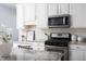 Kitchen with stainless steel appliances, subway tile backsplash, and white cabinets at 4913 Stockton Way, Durham, NC 27707