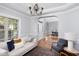 Bright living room with hardwood floors, stylish furniture, and elegant chandelier at 4913 Stockton Way, Durham, NC 27707