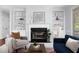 Cozy living room featuring a fireplace with black marble and built-in shelves at 4913 Stockton Way, Durham, NC 27707