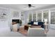 Inviting living room with a fireplace, built-in shelves, and lots of natural light at 4913 Stockton Way, Durham, NC 27707