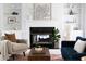 Living room features a black fireplace, built in white bookshelves, modern furniture and decor at 4913 Stockton Way, Durham, NC 27707