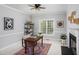 Office space with neutral walls, a vintage desk and black shelving at 4913 Stockton Way, Durham, NC 27707