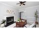Office space with neutral walls, a vintage desk, black shelving and fireplace at 4913 Stockton Way, Durham, NC 27707