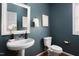 Powder room with navy walls, unique sink and toilet at 4913 Stockton Way, Durham, NC 27707