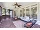 Well-lit screened porch with ceiling fan and modern outdoor seating at 4913 Stockton Way, Durham, NC 27707