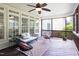 Cozy screened-in porch with wood floors, stylish seating, and a ceiling fan for warm days at 4913 Stockton Way, Durham, NC 27707