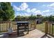 Outdoor deck with grill and playhouse, perfect for outdoor gatherings and summer fun at 50 Waterford Dr, Angier, NC 27501