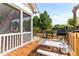 Wooden deck with a grill, propane tank, picnic table and a view of the lush backyard at 50 Waterford Dr, Angier, NC 27501