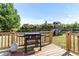 Grilling area on a well-maintained back deck with a playhouse in the backyard at 50 Waterford Dr, Angier, NC 27501